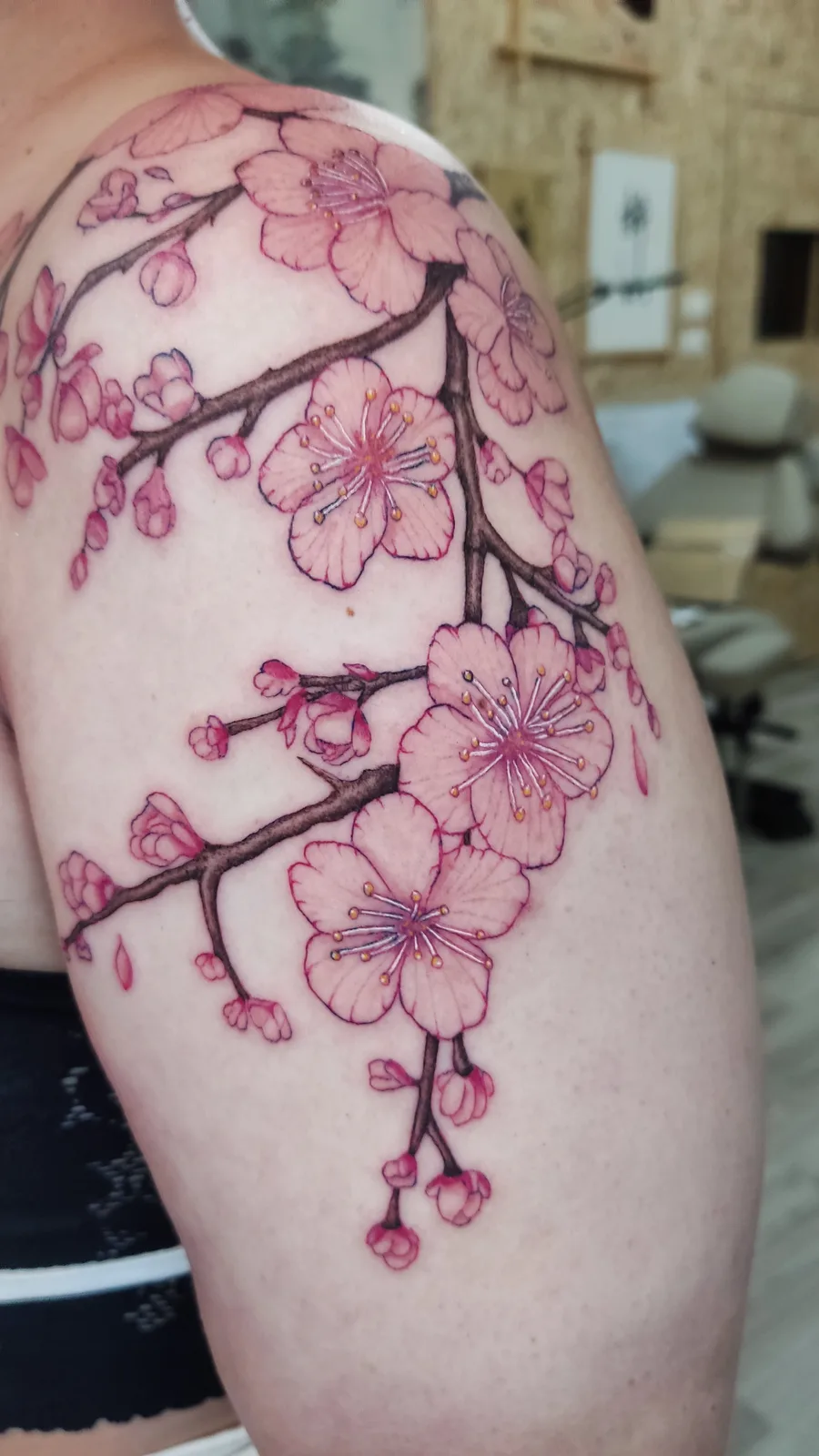 Pink cherry blossom branch on the thigh