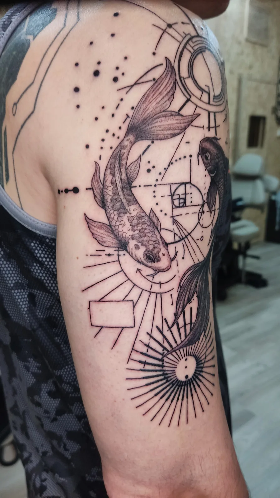 Surreal composition with fish and stars on the arm